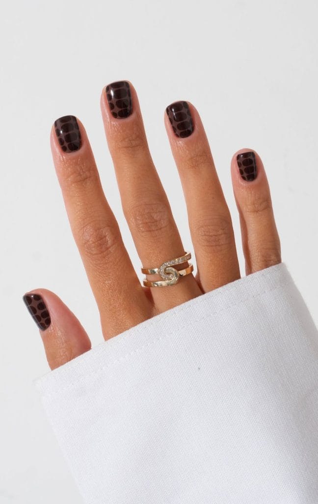 Short fall nails with light brown base and dark chocolate snake print design