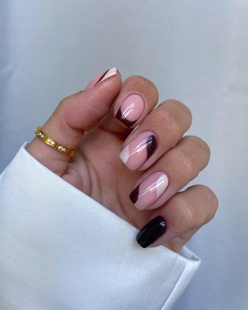 Short fall nails with sheer pink base, cream and burgundy curved accents, burgundy French tip, and solid burgundy nail