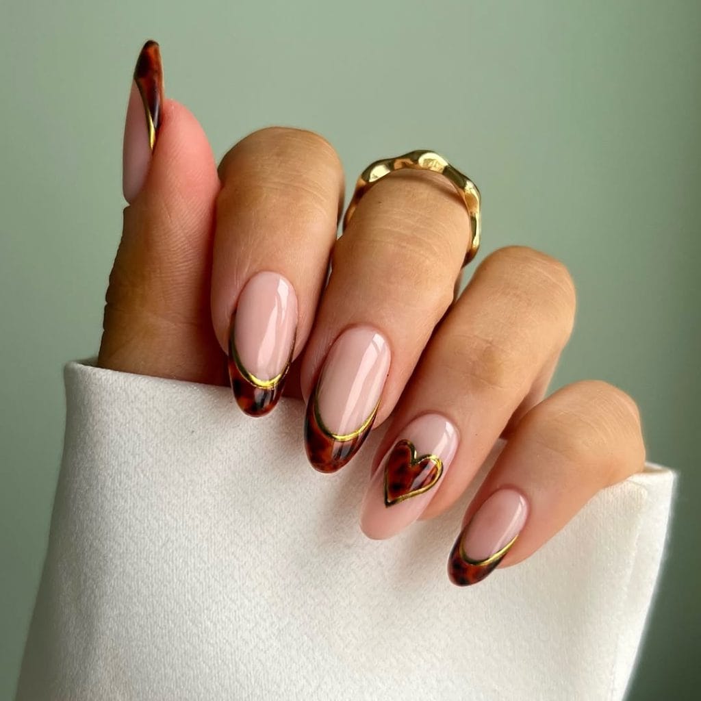 Long almond fall nails with pink base, tortoiseshell French tips, and gold outline details