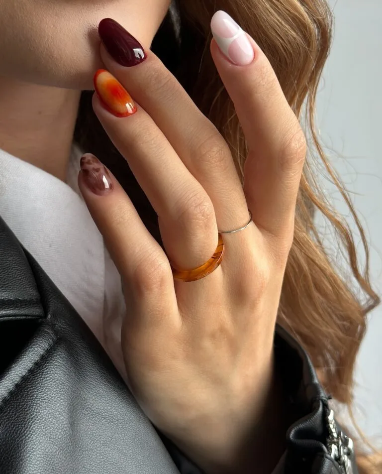Short oval autumn nails mixing amber jelly, deep wine, milky swirl and brown leopard print