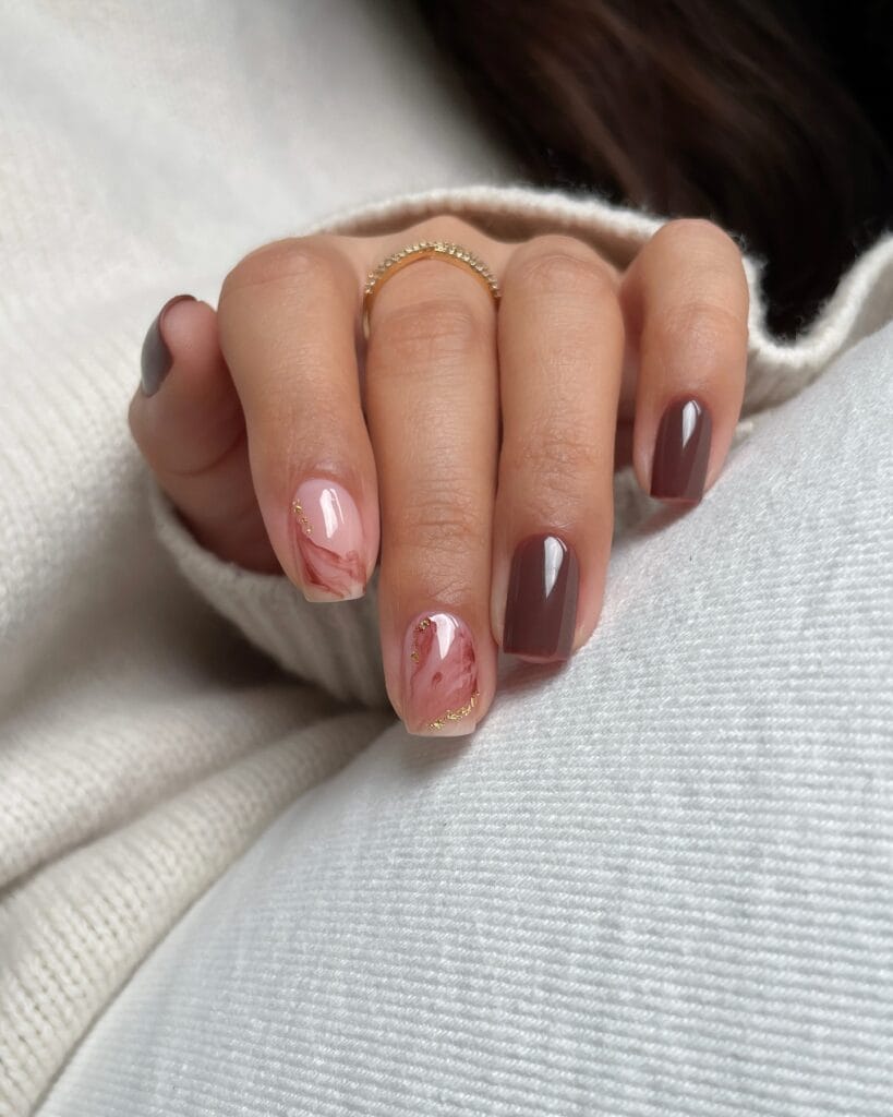 Short square fall nail ideas in glossy mocha brown with rose-brown marble and gold foil flecks