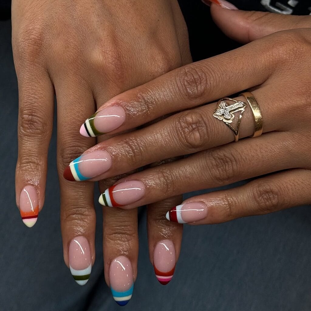 Almond autumn nails with thin stacked stripe French tips in olive, rust, blue and burgundy