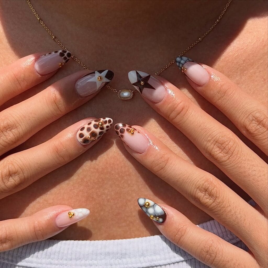 Long almond fall nails with leopard print, black star art, stone marble tips and gold bead accents
