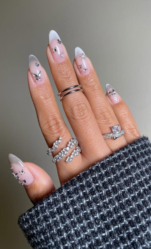 ong almond August nails with soft pink base, white French tips and crystal butterfly rhinestone accents