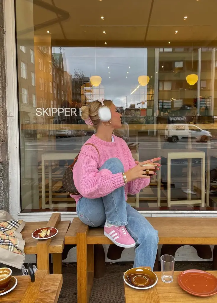 cozy fall outfit with pink chunky knit sweater, straight-leg jeans and pink Adidas sneakers