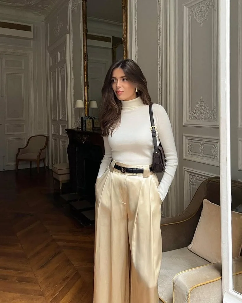 Elegant old money outfit with cream turtleneck, wide-leg trousers and black leather accessories