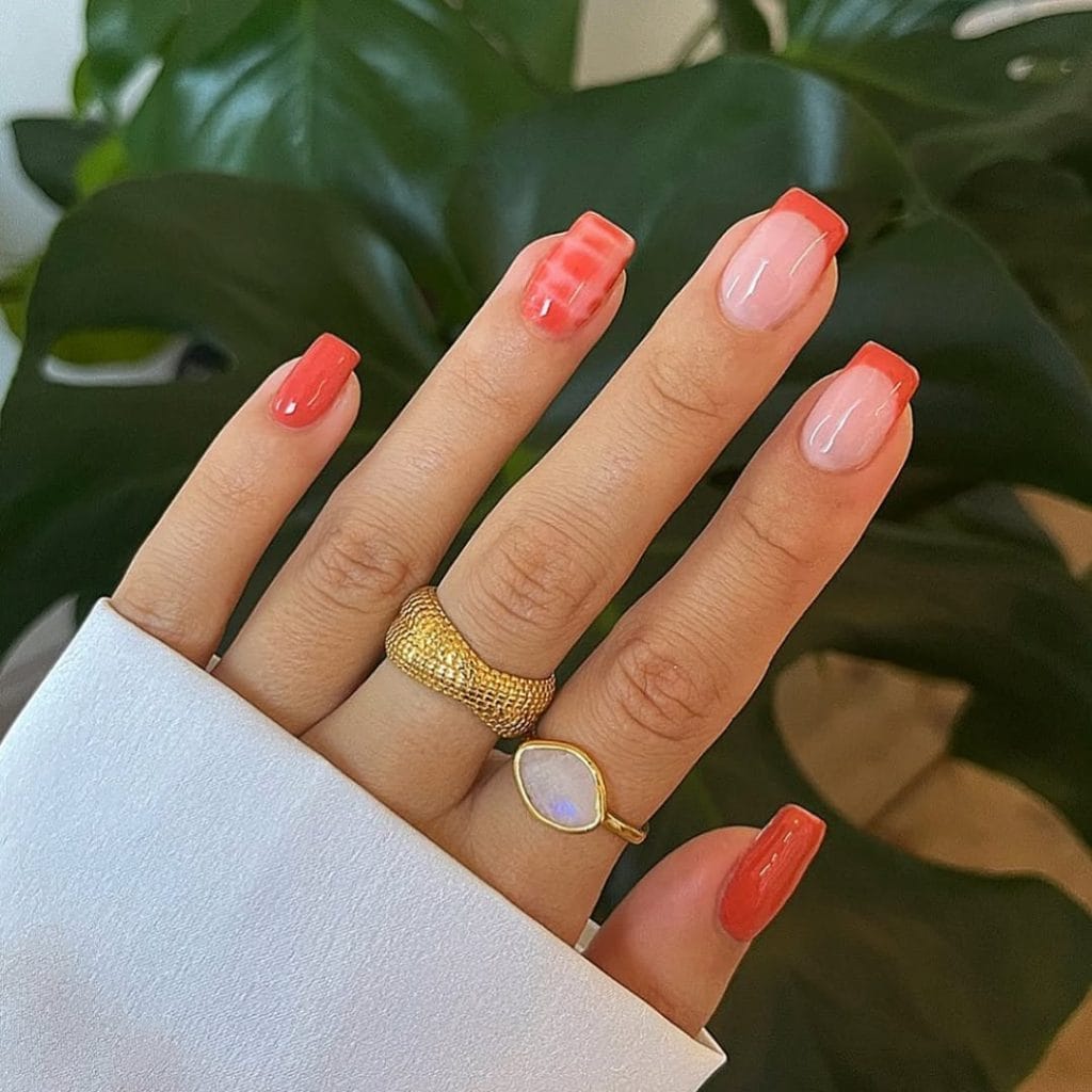 Fall nails with coral French tips and snake print

