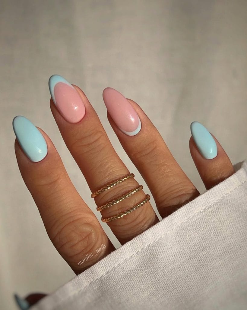 almond August nails with solid sky blue and dusty pink base featuring classic and reverse French tip designs