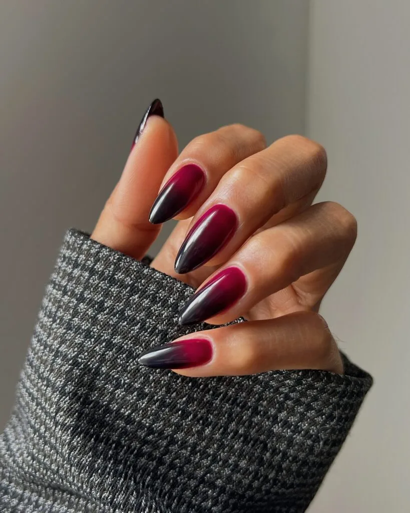 Long pointed fall nails with glossy berry-red bases fading into black tips.
