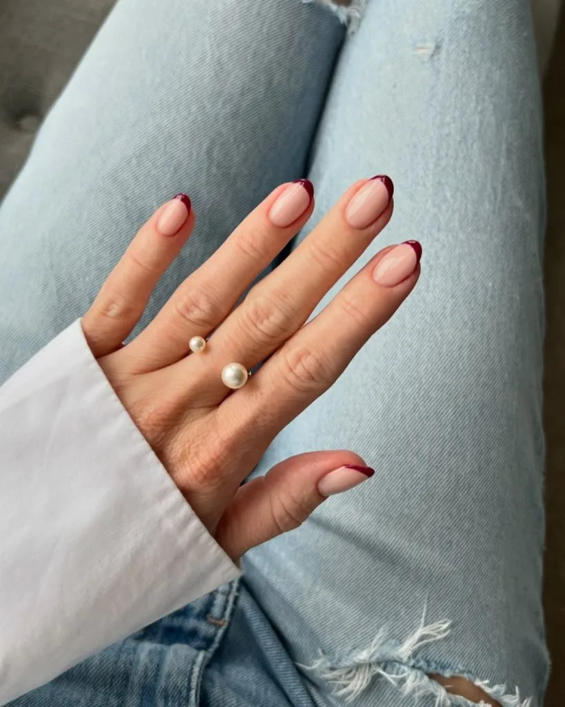 Short oval old money fall nails with nude base and burgundy French tips