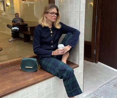 Parisian fall outfit with navy cardigan, tartan plaid pants, black mary jane heels