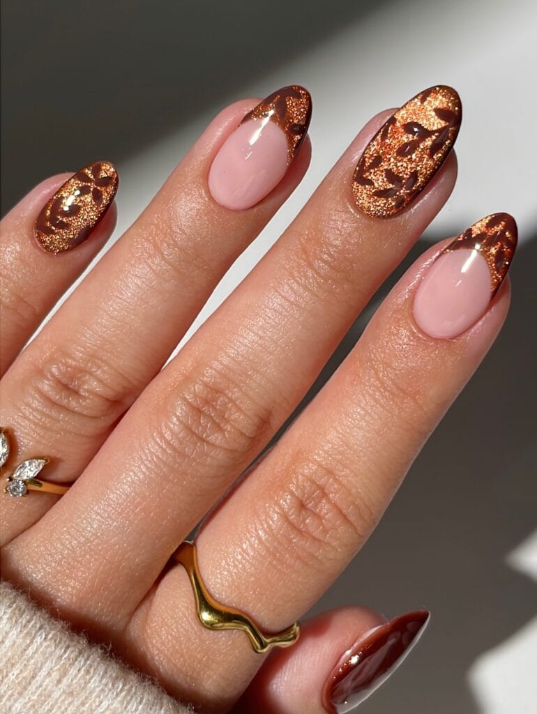 Autumn nails with copper glitter cat-eye and brown leaf prints, mixing full nails and French tips over sheer pink