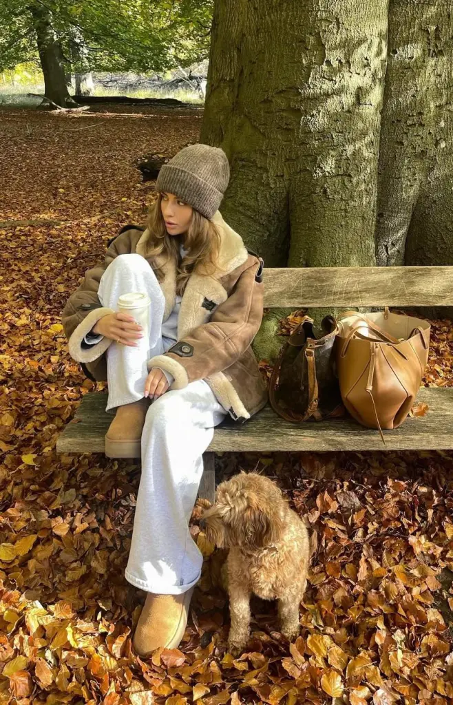 Cozy fall outfit with tan shearling jacket over white sweatsuit, gray ribbed beanie and tan Ugg boots