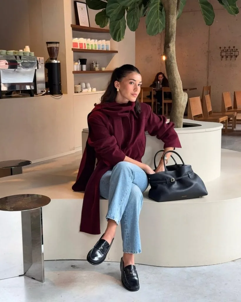 Casual fall outfit with burgundy jacket, matching scarf, light wash straight-leg jeans, black penny loafers
