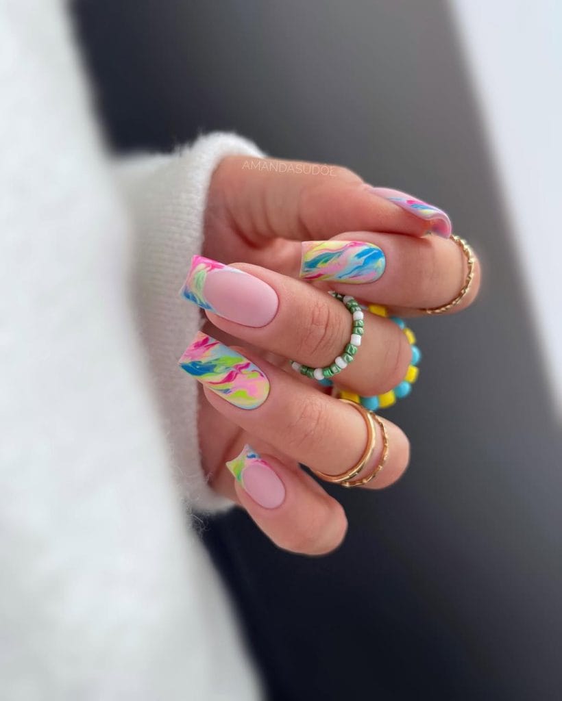 long square summer nails with soft pink base and colorful abstract swirl patterns in rainbow colors