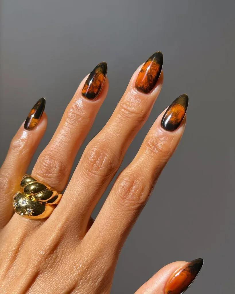 Long almond old money fall nails with burnt sugar design in amber and caramel tones