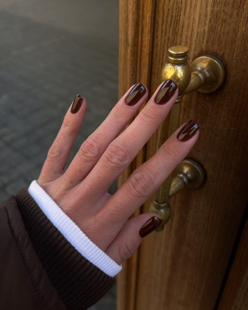 Elegant square nails with glossy deep chocolate-brown polish.
