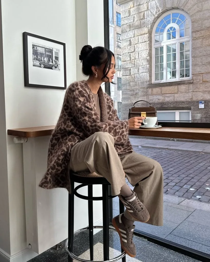 Casual fall outfit with brown leopard print cardigan, beige wide-leg trousers, brown sneakers
