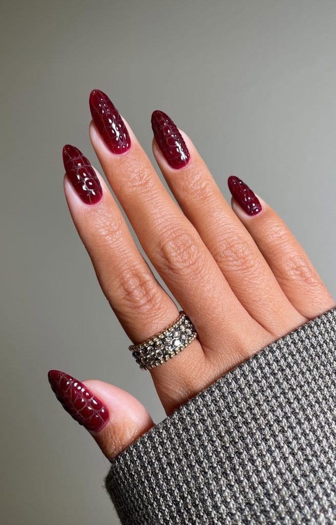 Almond September nails with 3D crocodile texture in dark cherry