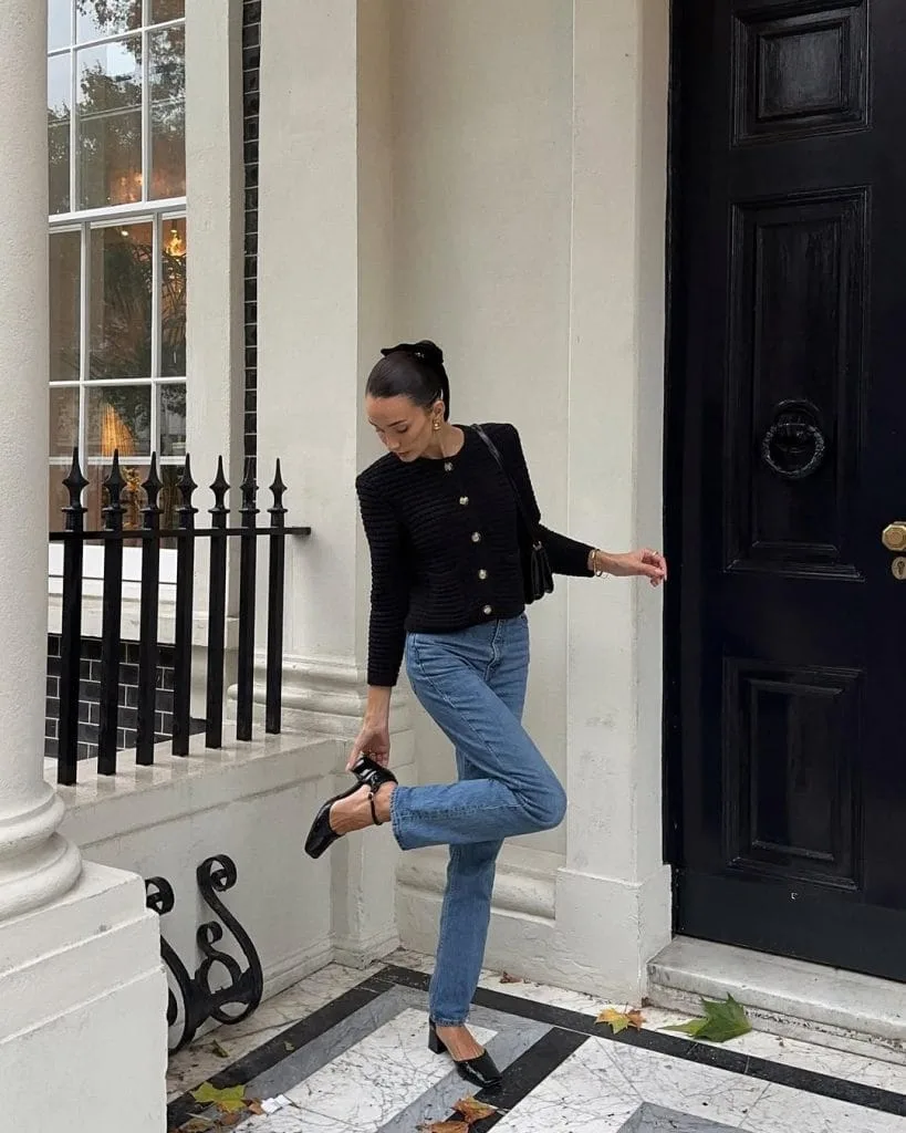 Classic old money outfit with black button cardigan, blue straight jeans and black heels