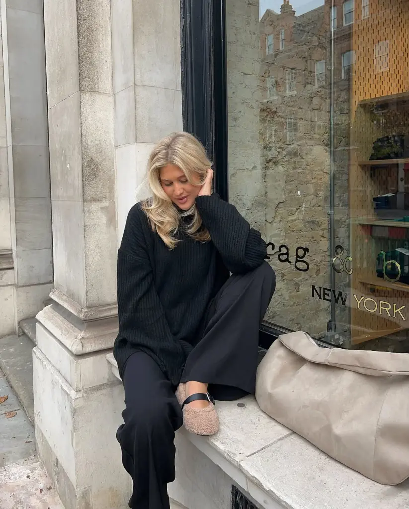 fall outfit with black ribbed oversized sweater, matching wide-leg trousers, textured flats and beige leather tote bag
