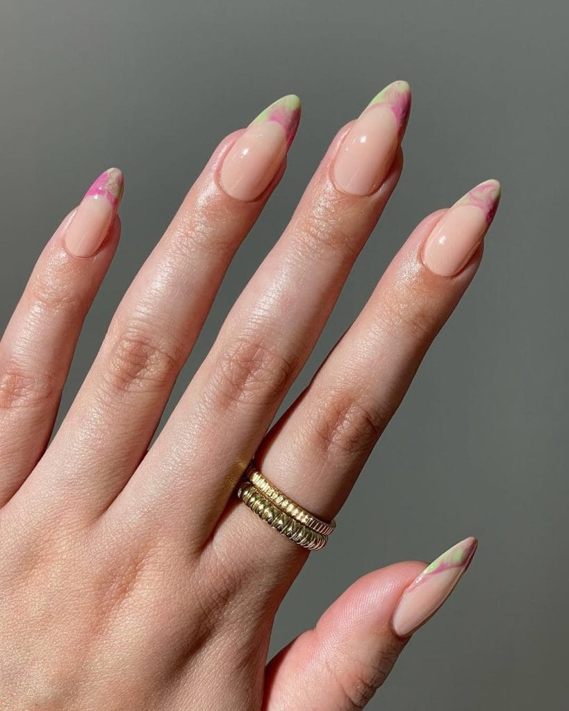 Long almond August nails with nude base and tie-dye French tips in pink, green and purple