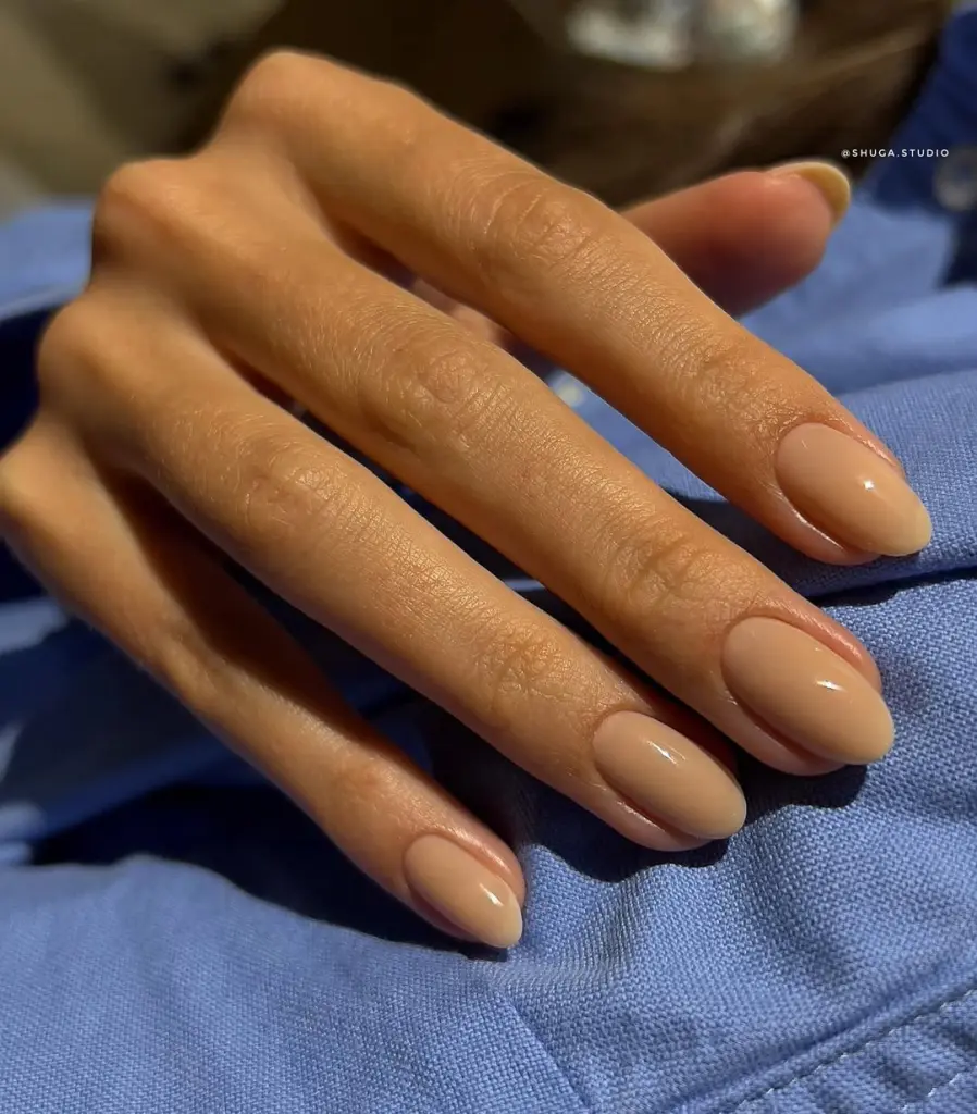Caramel brown neutral nails on long almond shape with glossy finish