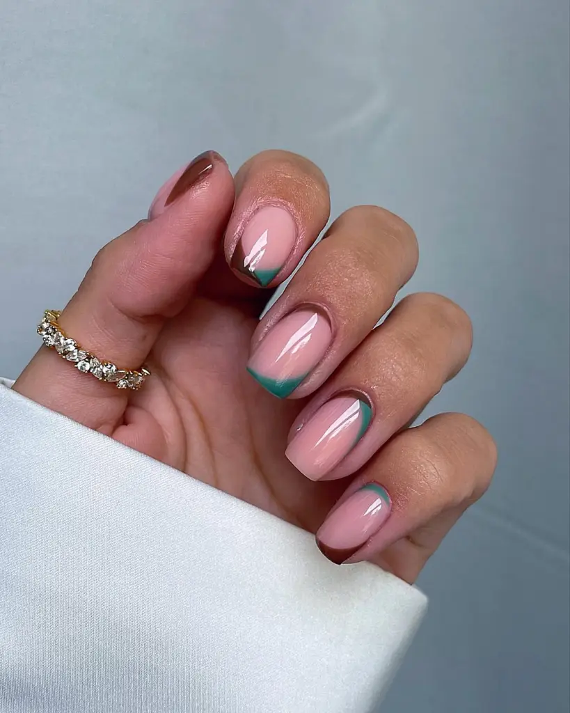 Short fall nails with mixed French tip variations in dark green and chocolate brown on clear base
