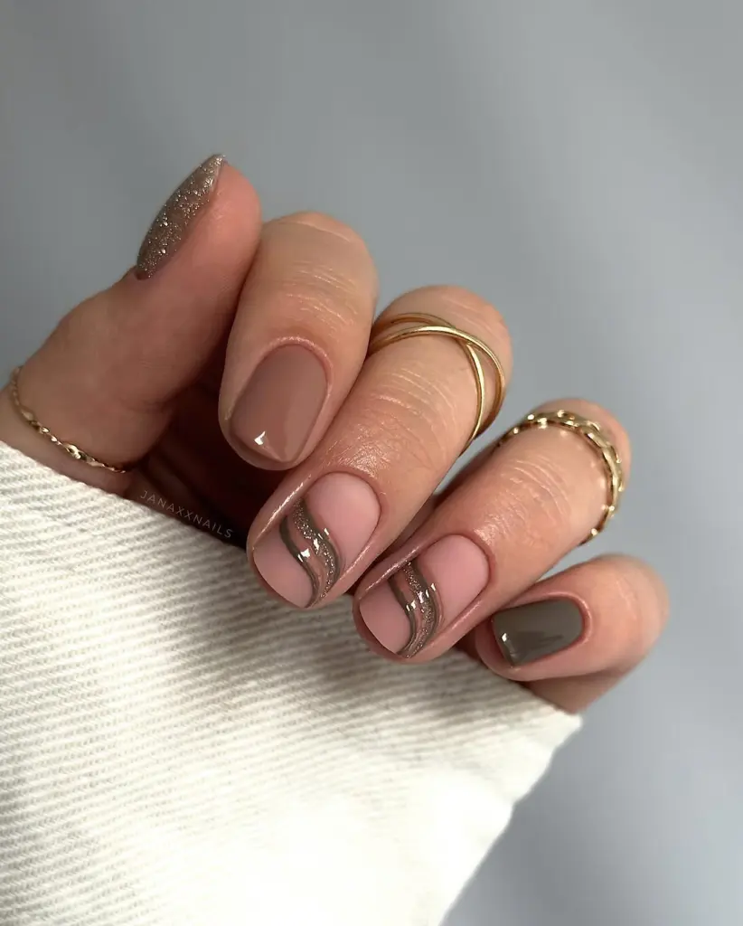 Fall short nail designs in nude, beige, and brown with gold glitter and curved line art