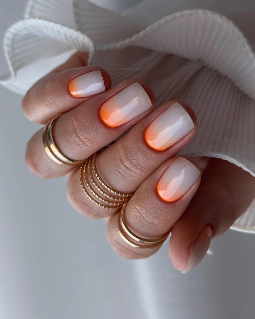 hort August nails with milky nude base and orange gradient from cuticle area
