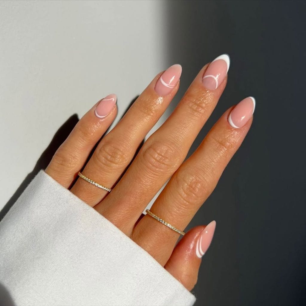 Pink fall nails with mixed French tip designs
