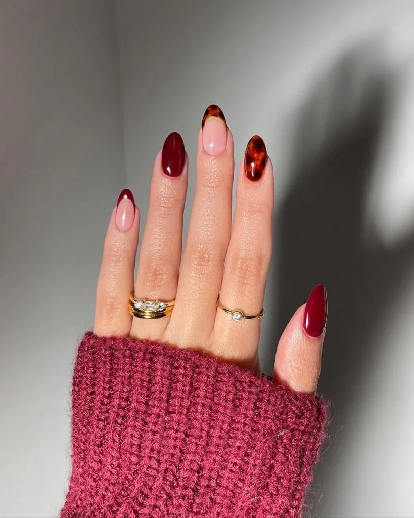 September nails with burgundy polish and tortoiseshell accent nails
