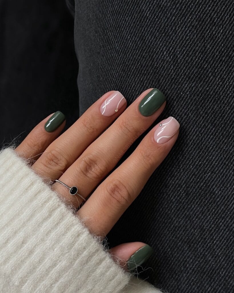 Muted olive and blush autumn nails with white line art and metallic accents, text reads