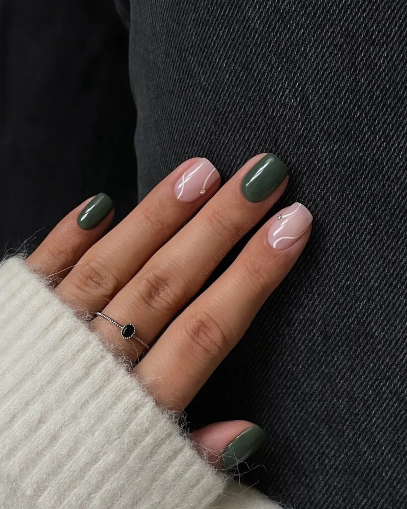 Muted olive and blush autumn nails with white line art and metallic accents, text reads