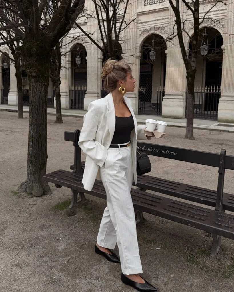 classy fall outfit with cream pinstripe suit, black tank top and black pointed flats