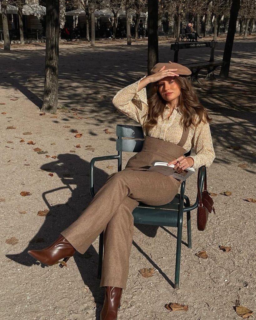 Parisian fall outfit with camel beret, cream blouse, brown suspender pants
