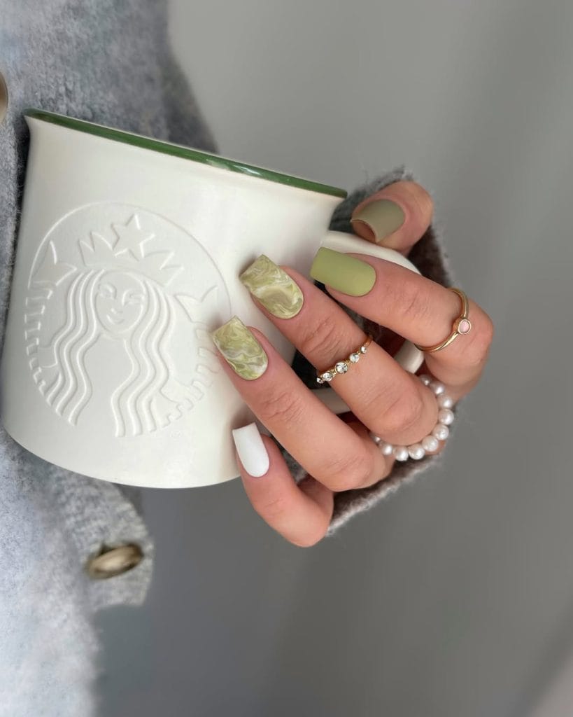 long square summer nails with sage green polish, green marble patterns, and white accent nail