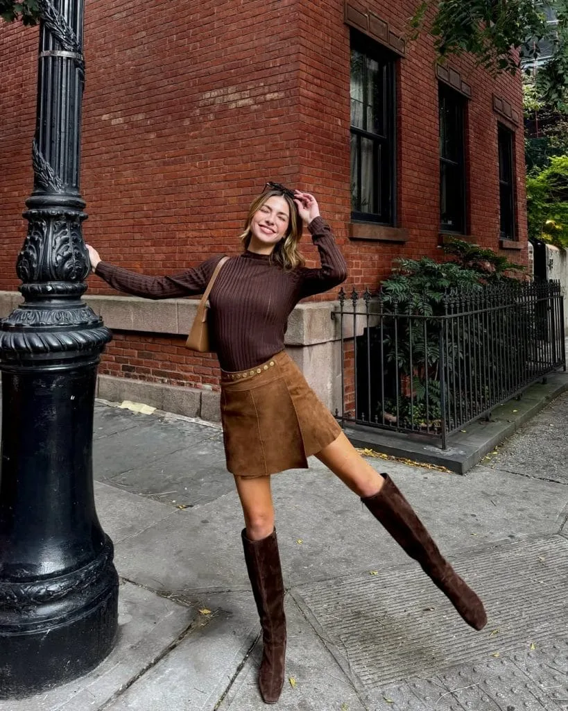 Casual fall outfit with brown ribbed long-sleeve top, brown suede mini skirt, brown suede knee-high boots

