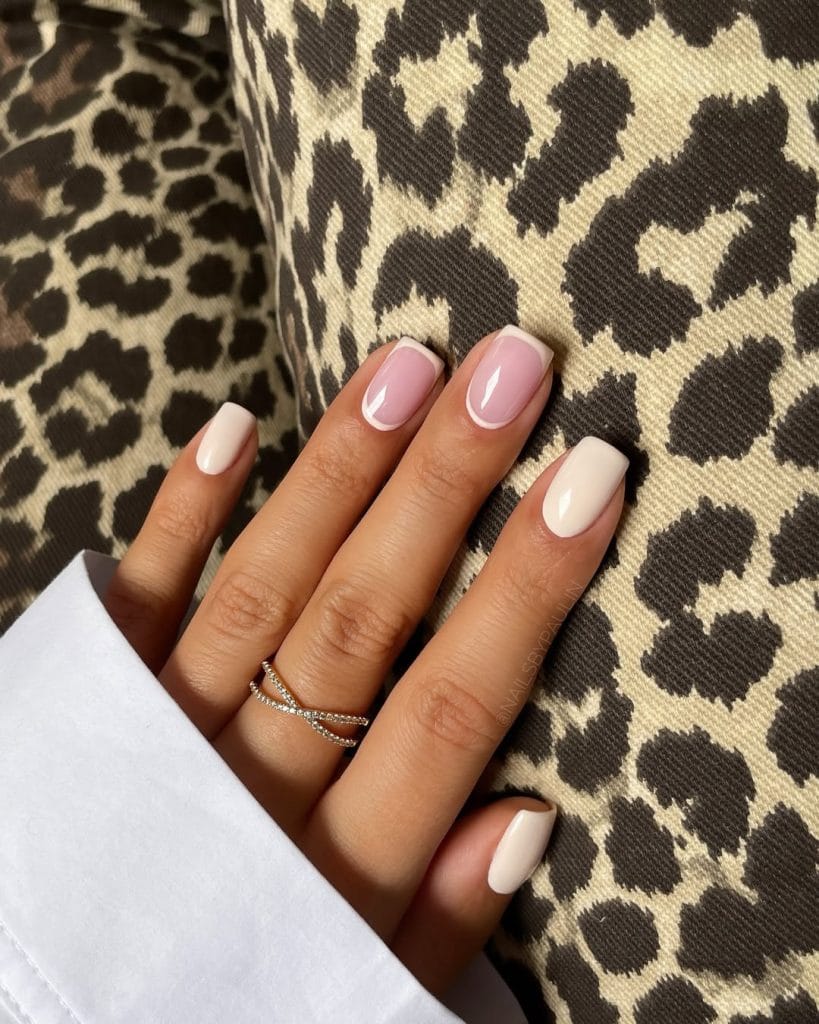 Short August nails with cream base and accent nails featuring double French tips in milky pink