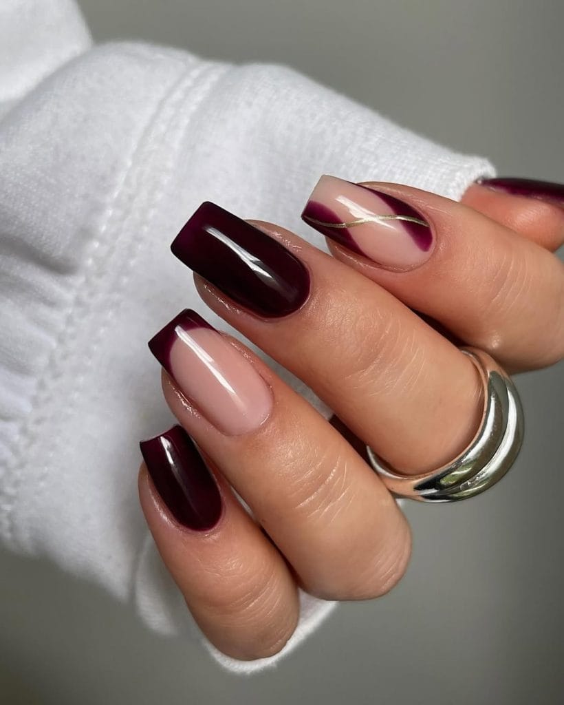 Mixed burgundy fall nails with French tips and gold curve designs