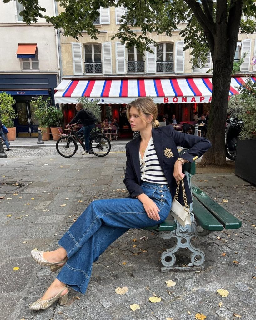 Parisian fall outfit with navy blazer, striped shirt, wide-leg jeans, woven slingbacks