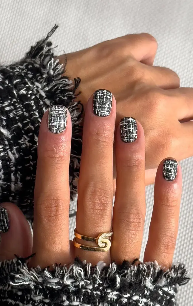 Short fall nails with black and white tweed pattern design and textured finish