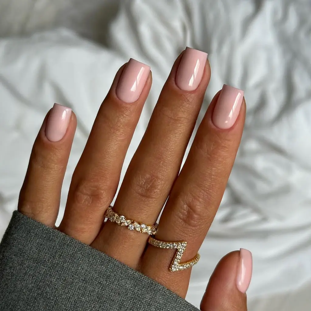 Beige pink neutral nails on short square shape with glossy finish