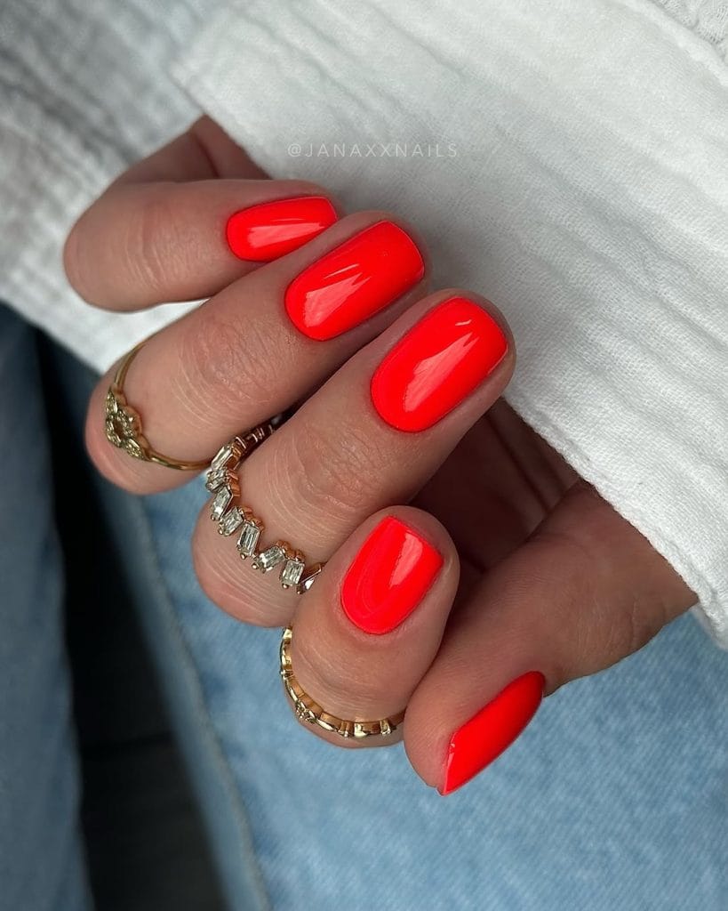 short summer nails with bright electric red polish and glossy finish