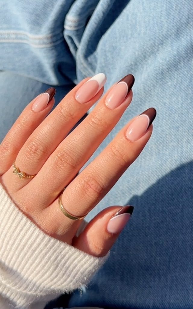 Mixed brown and white fall French tip nails on oval shaped nails with pink base