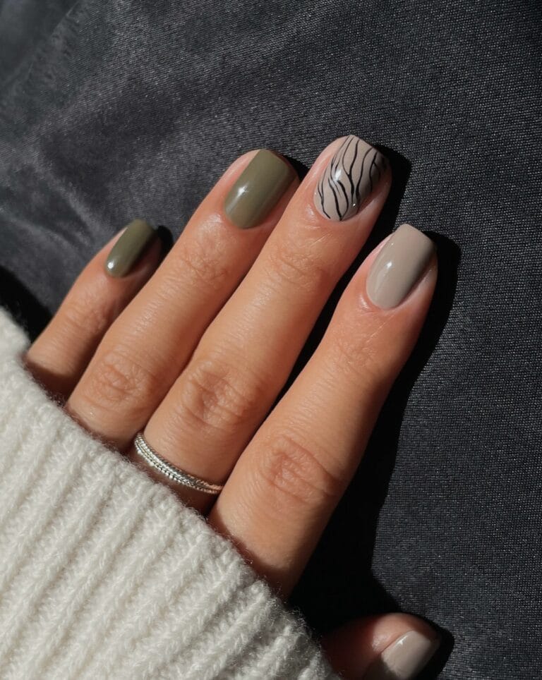 Short nail designs in muted olive and taupe with one black wavy line-art accent.
