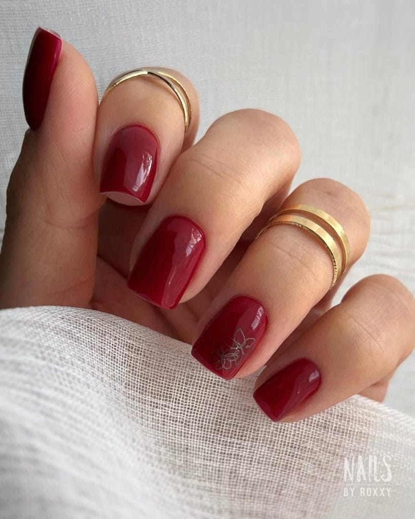 Red classy fall nails with black flower detail