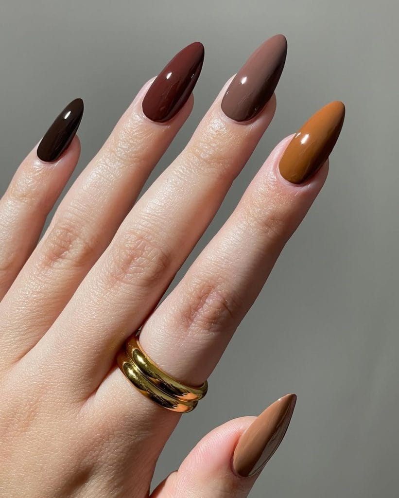 fall nails with different fall colors including brown, rust, and burgundy