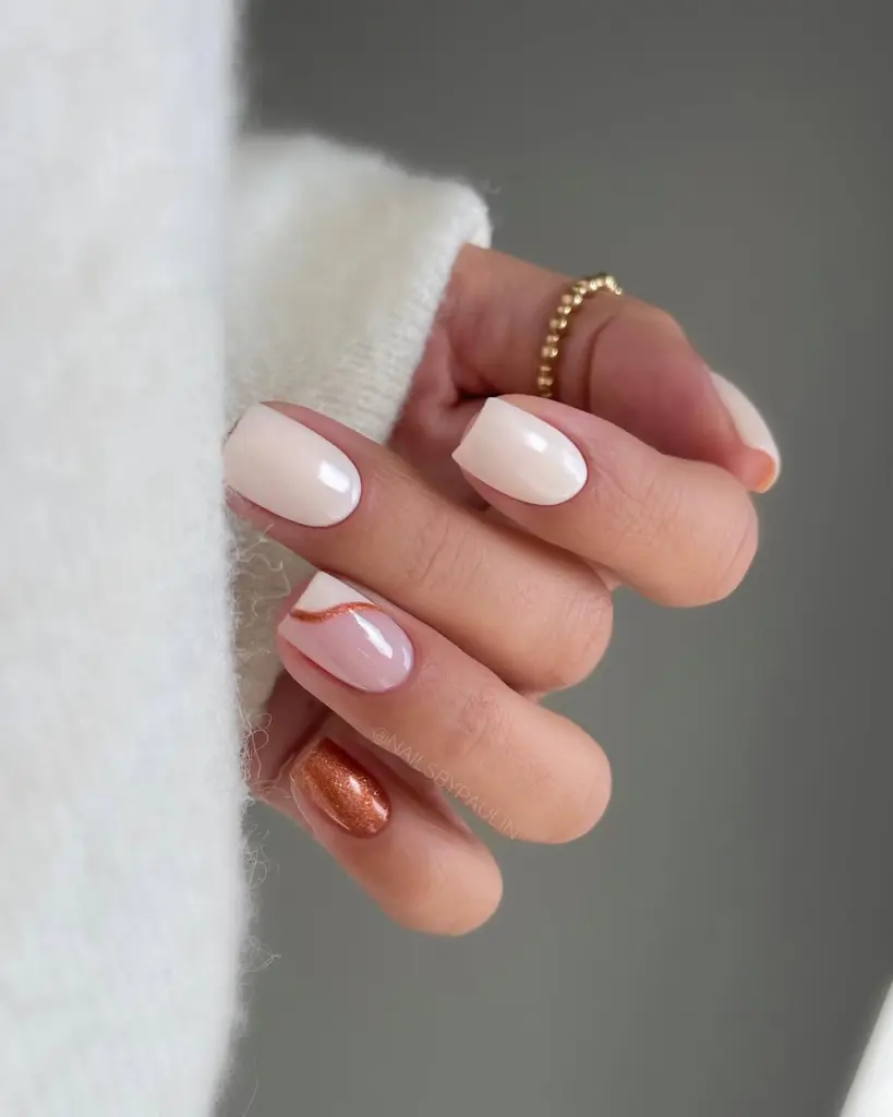 Short fall nails in cream and milky white with copper shimmer accent and copper curved line detail