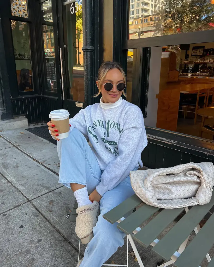 Cozy fall outfit featuring vintage gray sweatshirt layered over white turtleneck with light wash jeans and platform Ugg slippers